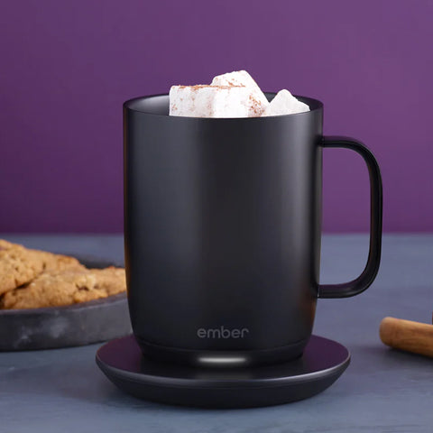 Ember Mug² filled with a Chai Spiced Hot Chocolate sits next to cinnamon sticks.