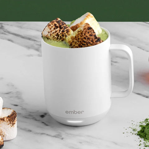 A white Ember Mug is filled with warm matcha and scorched marshmallows.